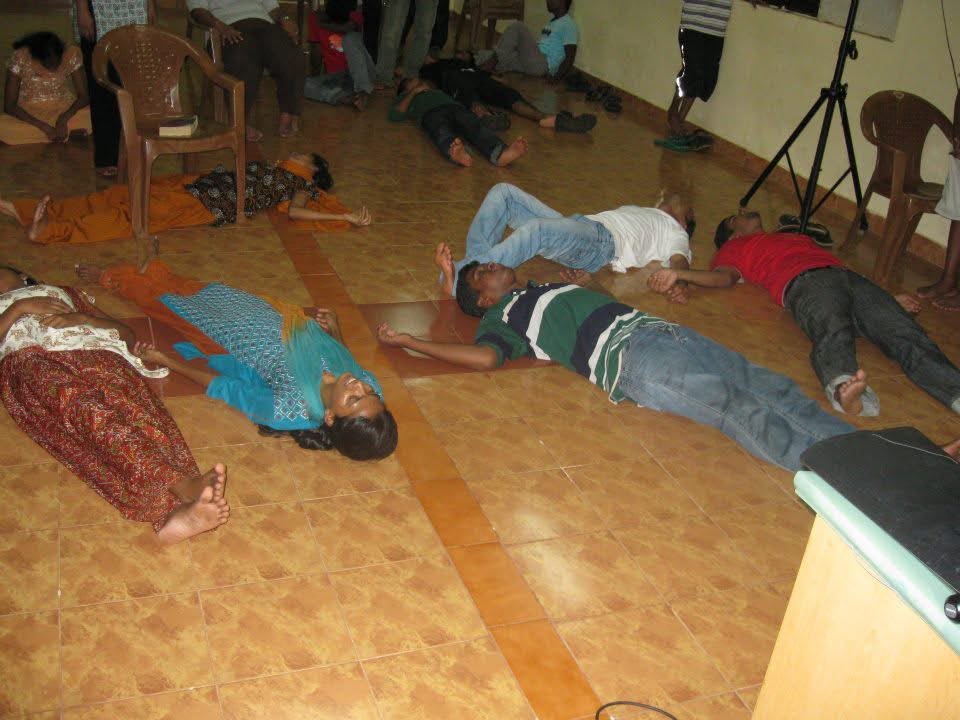 People resting in worship during an Awake Ministries gathering